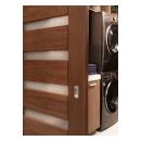 A TM9350 barn door in walnut with Nutmeg stain and Bamboo Rings resin conceals the laundry room from the dining room.