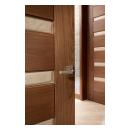 A TM9340 door, in walnut with Nutmeg stain and Shagreen Café Latte leather, opens to a large study which doubles as a guest room.