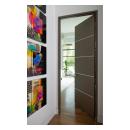Bedroom featuring a TMIR5000 door in quarter sawn white oak with Grey Mist stain and ½" bright stainless steel inlays.