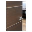 An attached bathroom features TMIR6000 doors in mahogany with ½" bright stainless steel inlay. Builder provided stain finish.