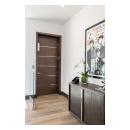 An elevator features a TMIR6000 door in mahogany with ½" bright stainless steel inlay. Builder provided stain finish.