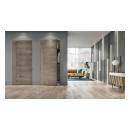 A living room features TMF1001 sketch face flush wood doors in White Oak with Grey Mist stain.