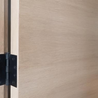 Detail of a TMF1000 flush door in quarter sawn white oak with custom ceruse finish.