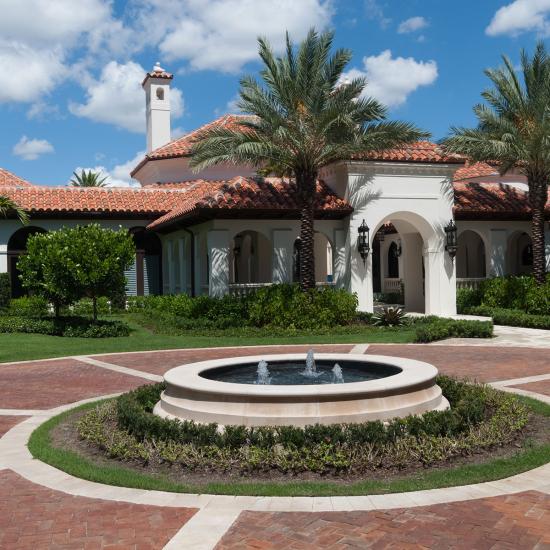 A round drive greets visitors to this renovated Palm Beach estate