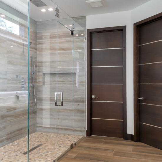 This master bath features TMIR6000 doors in mahogany with ½" bright stainless steel inlay. Builder provided stain finish.