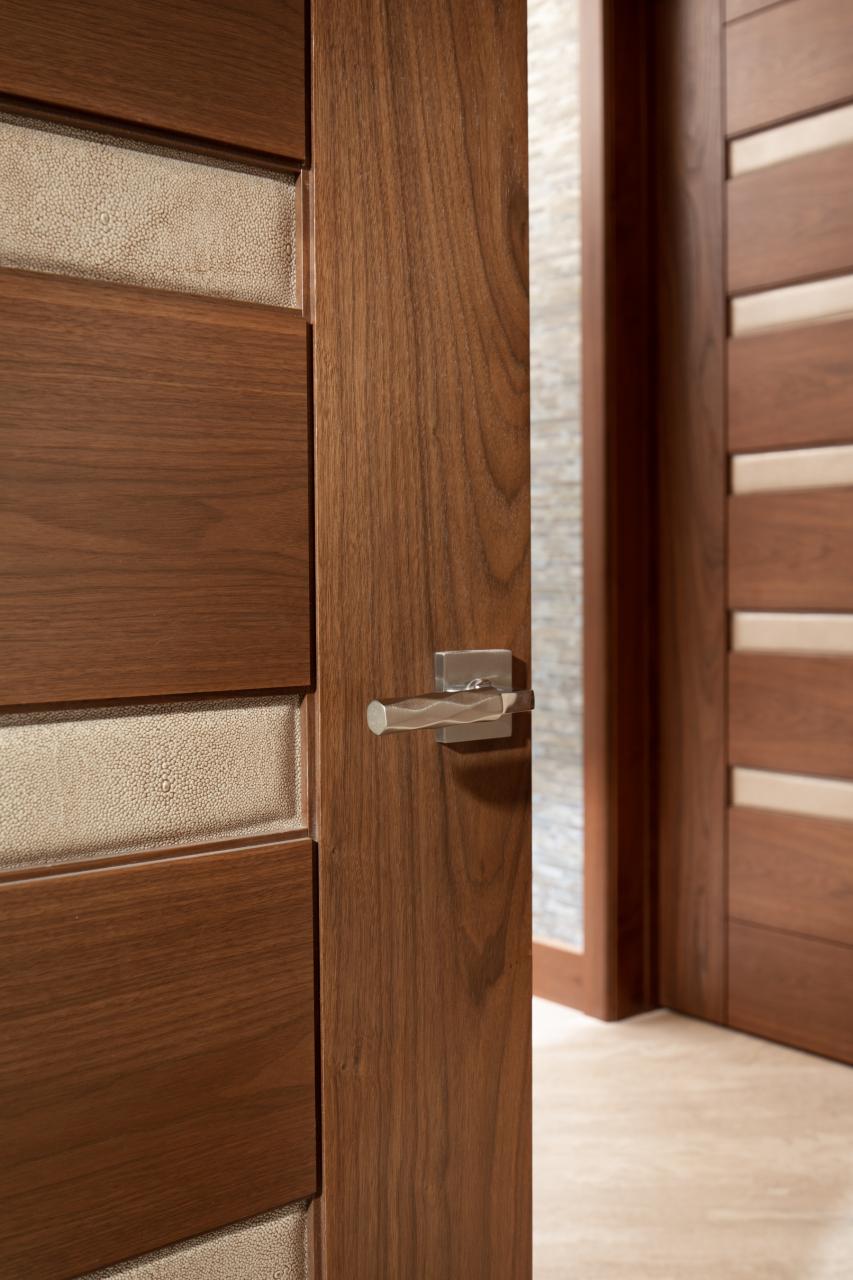 A TM9340 door, in walnut with Nutmeg stain and Shagreen Café Latte leather, opens to a large study which doubles as a guest room.