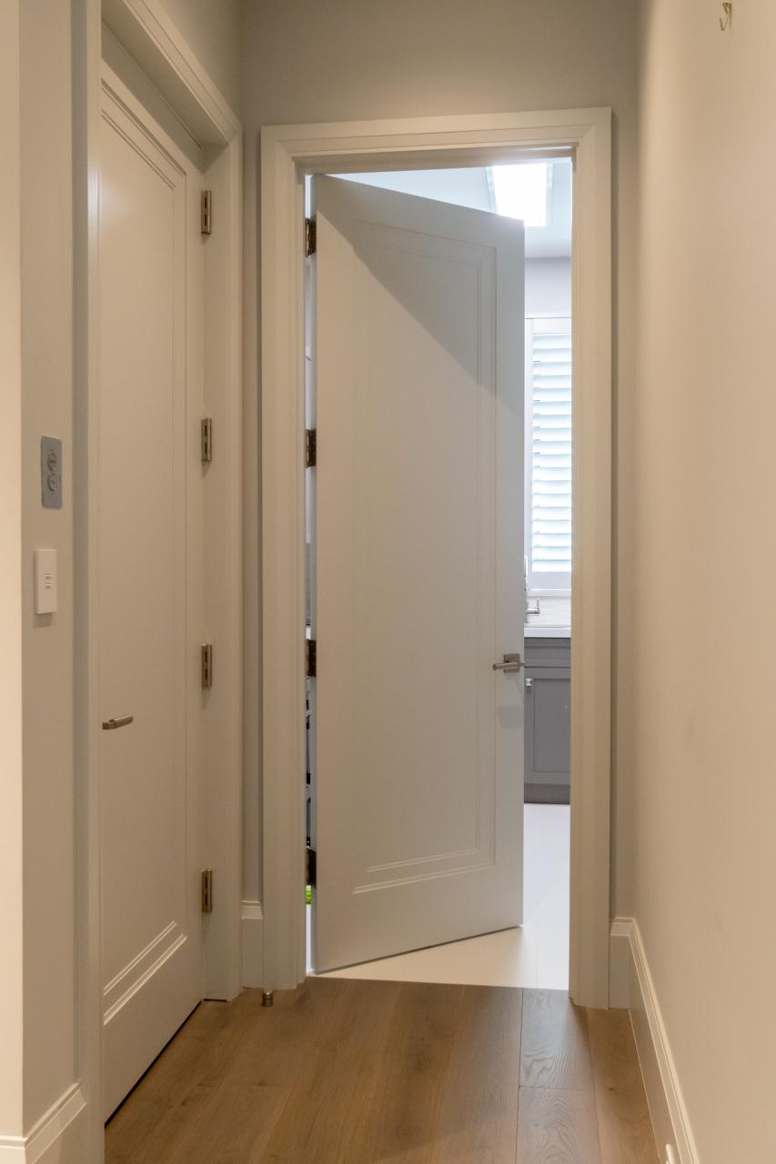 TS1000 doors in MDF with Miracle (MR) moulding and Flat (C) panel are used for both the elevator and laundry room.
