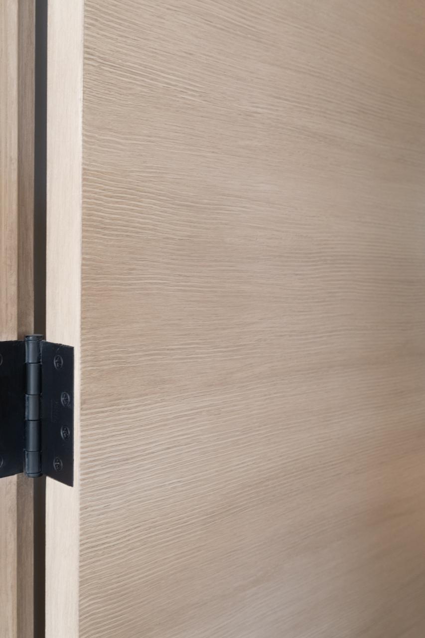 Detail of a TMF1000 flush door in quarter sawn white oak with custom ceruse finish.