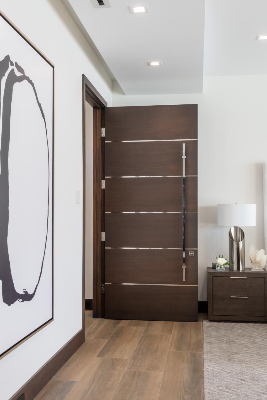 This master bedroom suite features TMIR6000 doors in mahogany with ½" bright stainless steel inlay. Builder provided stain finish.