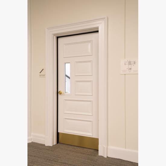 Custom fire-rated door in MDF with fire glass, Bolection (BM) moulding and Senior Raised (E) panel.