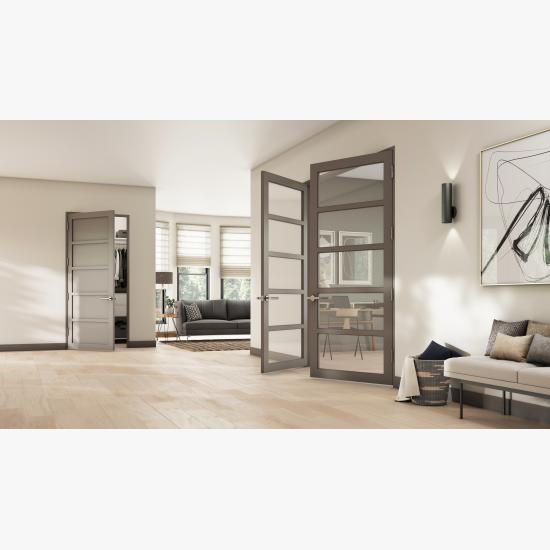 This living room features a pair of ultra narrow TMUN5000 doors in MDF with Square Stick (SS) sticking and clear glass. The door in back has a solid flat panels.